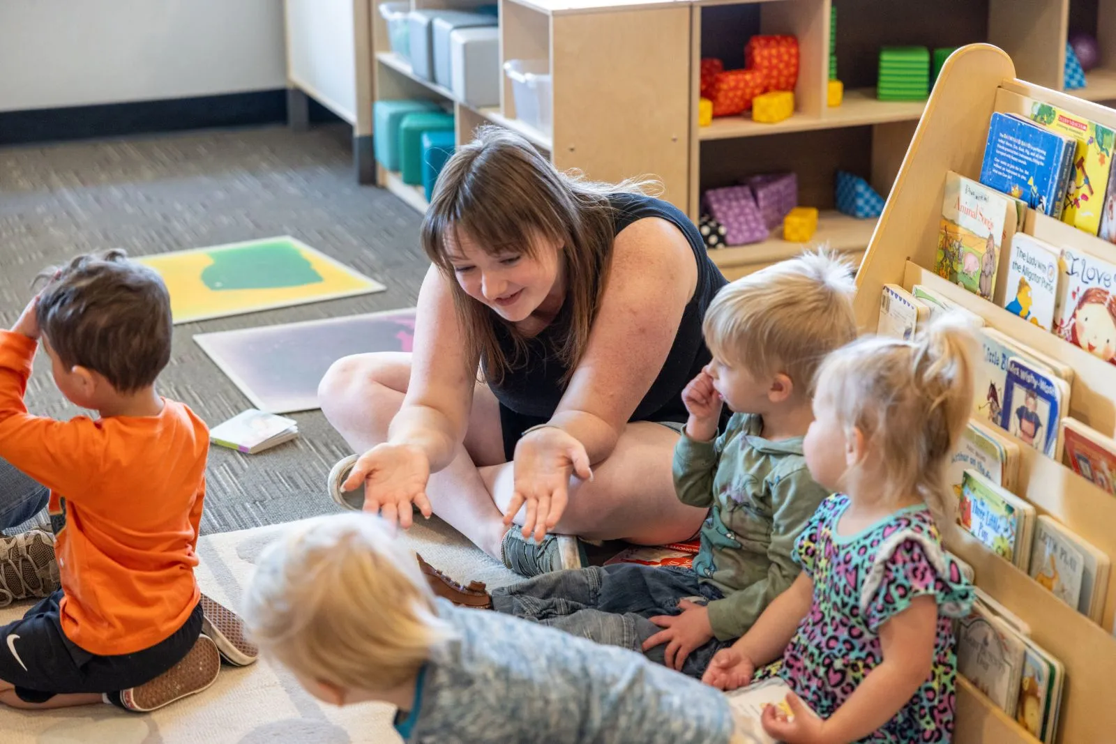 Teacher playing with toddler group at the FDC