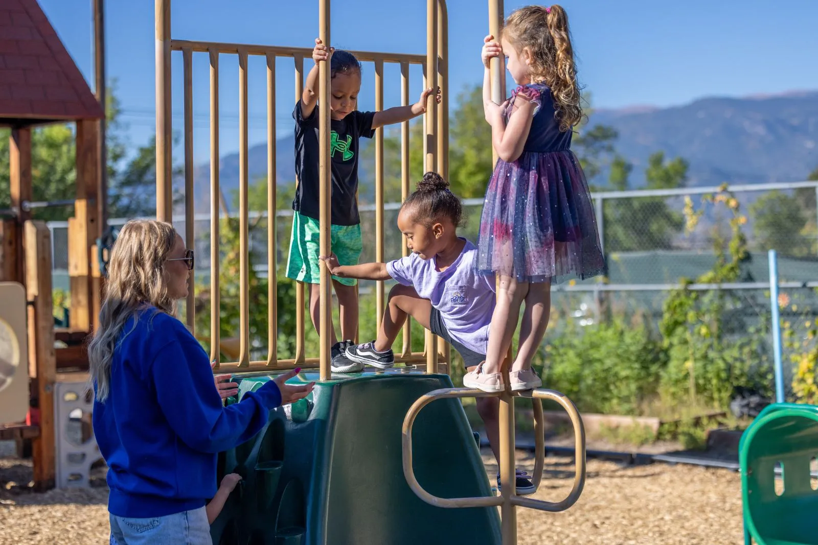 Teacher outside on playground with kids