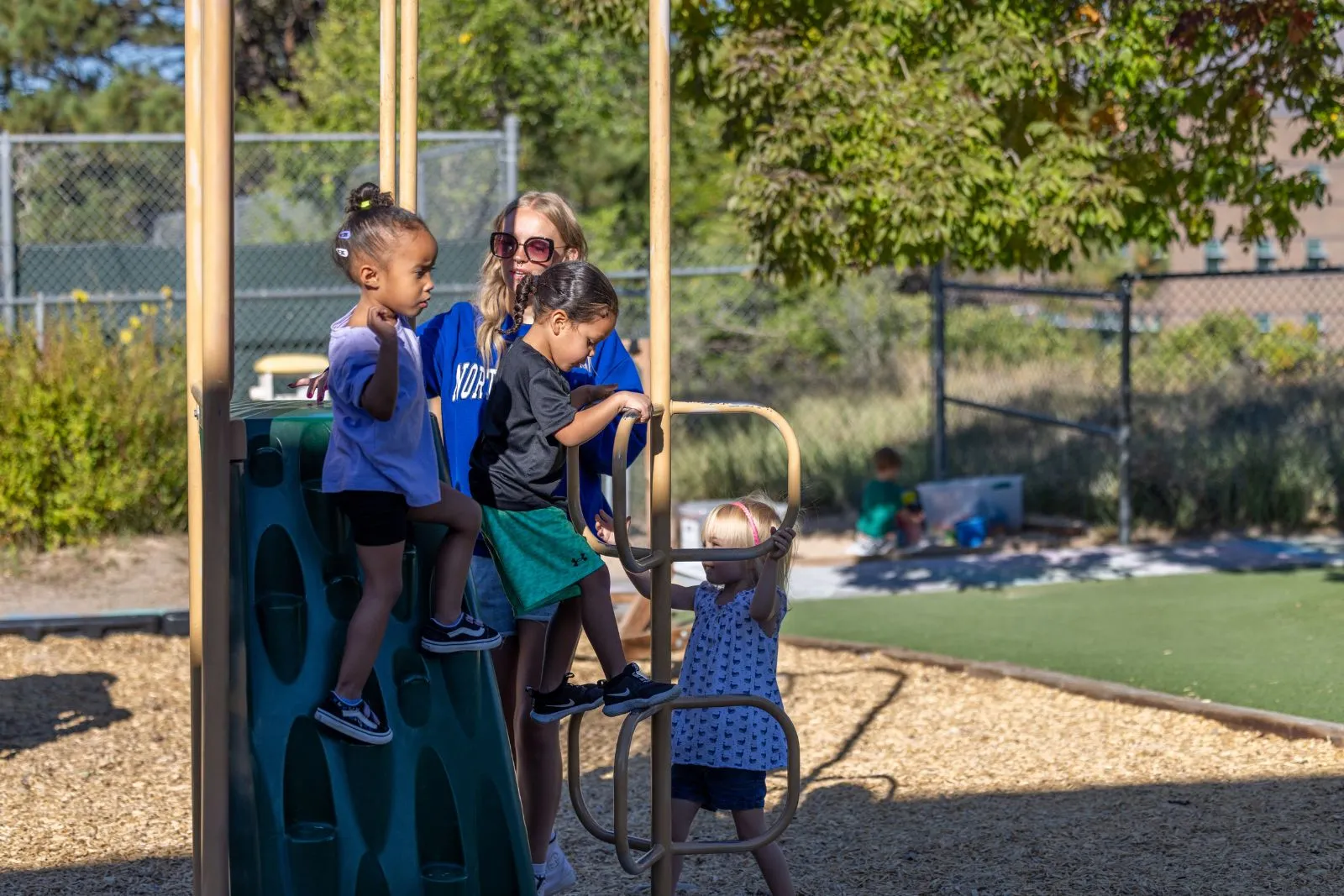 Teacher outside on playground with kids